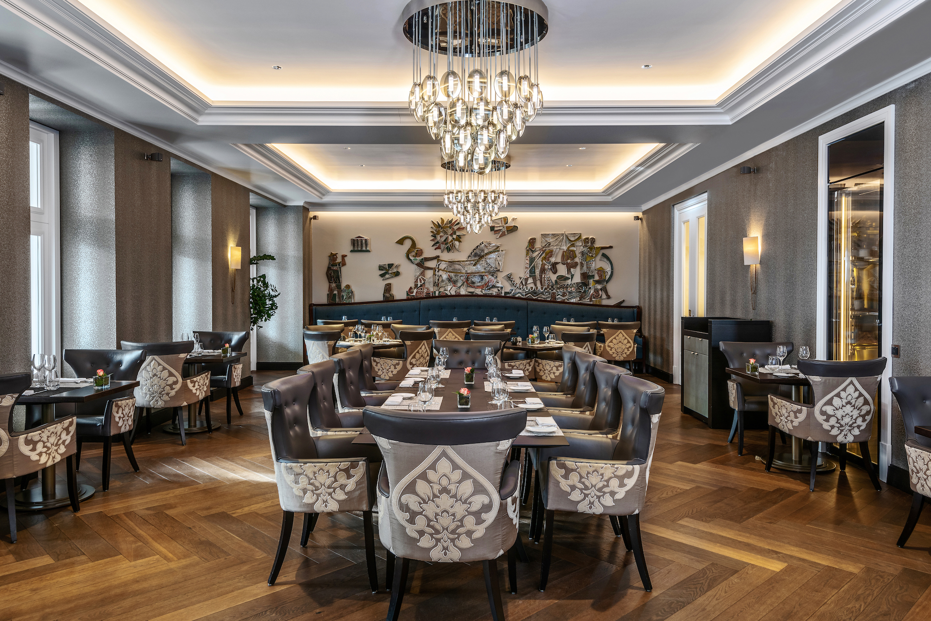 Elegant dining room with ornate silver and teal decor, creating a sophisticated atmosphere for culinary enthusiasts.