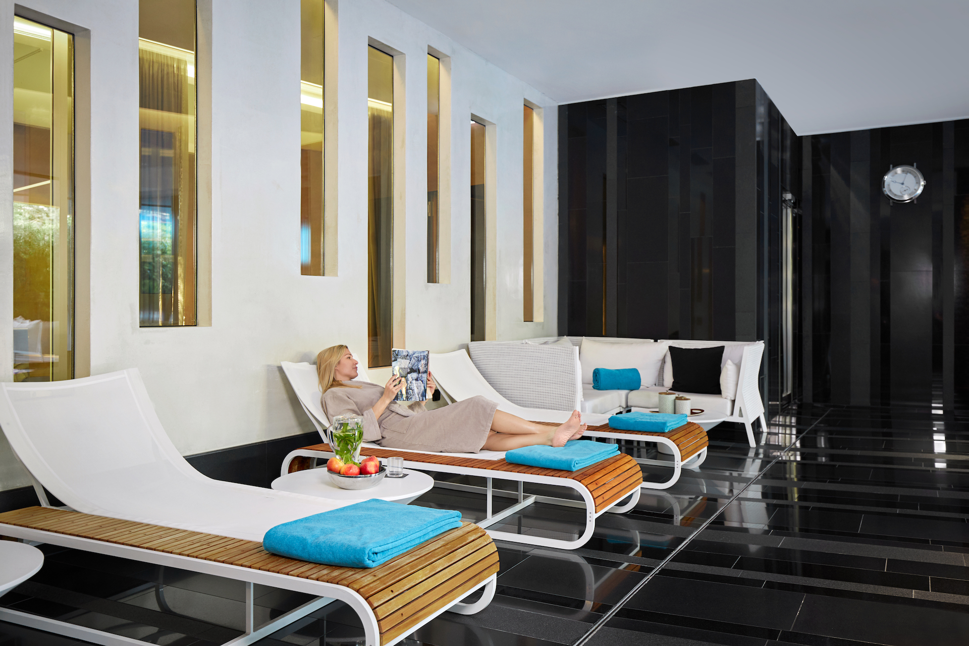 Sleek spa lounge with calming black and white decor, inviting relaxation and serenity for wellness enthusiasts.