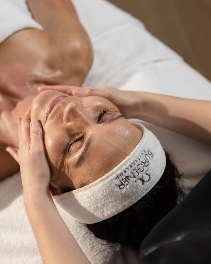 Gentle facial massage in a serene spa setting, highlighting soft earth tones for a calming, rejuvenating experience.